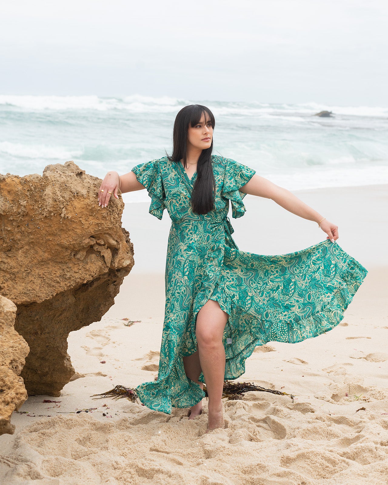 Emerald Midi Dress showcasing a lush green print with intricate patterns and flattering V-neckline